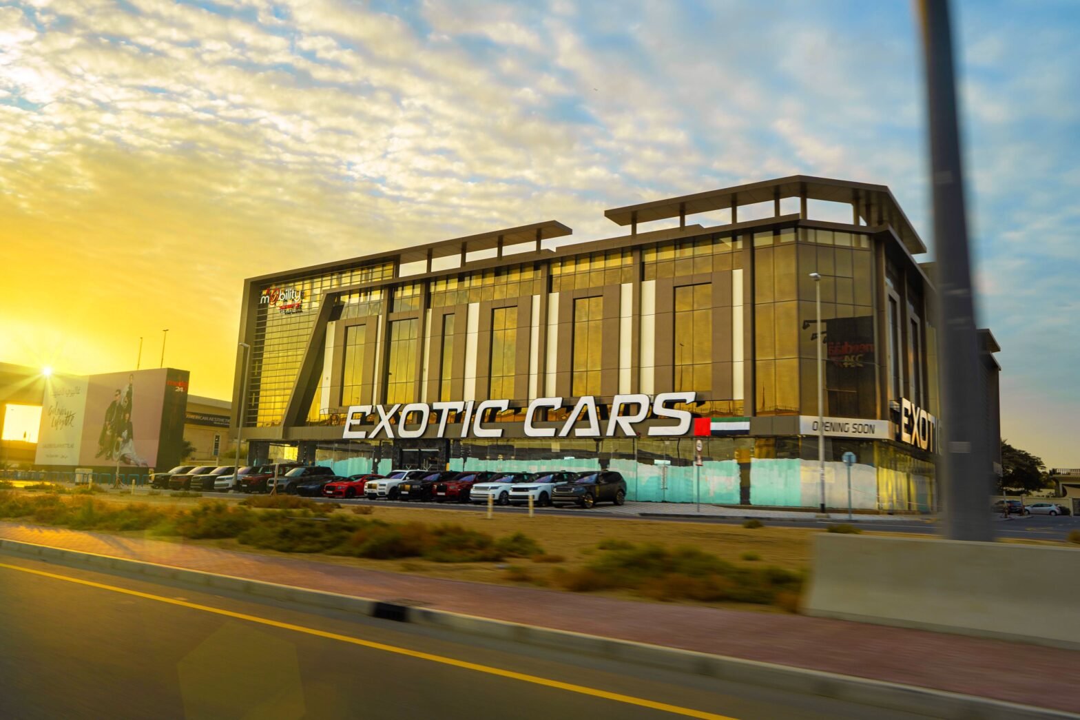 Luxury car showroom displaying new vehicles under bright lights with sales staff assisting